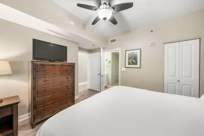 a bedroom with a bed and a flat screen tv at Shores Of Panama #1508 in Panama City Beach