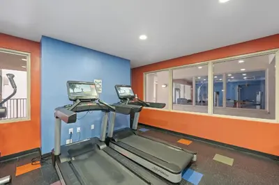 a gym with two treadmills in a room at Shores Of Panama #1508 in Panama City Beach