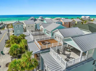 an aerial view of a house with the beach at Spectacular 3br 4ba w/ Private Pool, 2 Min Walk to Beach - Sleeps 15! in Panama City Beach