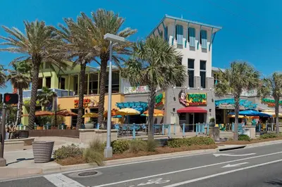 a street with palm trees in front of a building at Laguna Peach: 3BA 2BA retreat for 10! Explore nearby beaches & activities in Panama City Beach