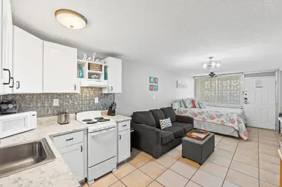 a kitchen and a living room with a couch at Fontainebleau Terrace #400 by Book That Condo in Panama City Beach