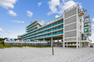 a building on the beach in front of a building at Fontainebleau Terrace #400 by Book That Condo in Panama City Beach