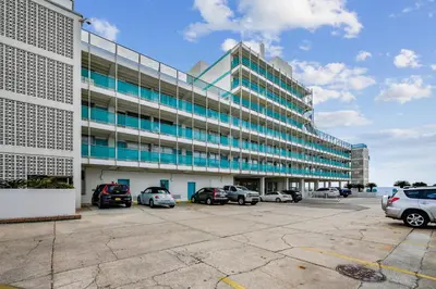 a large building with cars parked in a parking lot at Fontainebleau Terrace #400 by Book That Condo in Panama City Beach