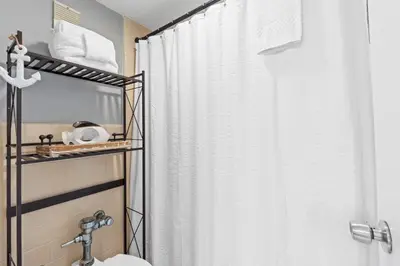 a bathroom with a shower curtain and a sink at Fontainebleau Terrace #400 by Book That Condo in Panama City Beach