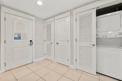 a room with white doors and a tiled floor at Grand Panama Beach Resort - The Grand #704 in Panama City Beach
