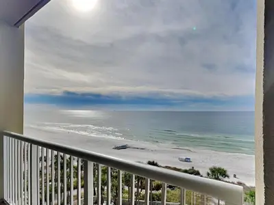 a view of the beach from the balcony of a condo at Grand Panama Beach Resort - The Grand #704 in Panama City Beach