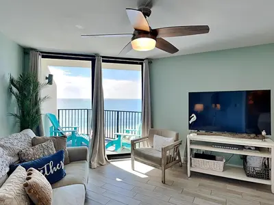 a living room with a couch and a flat screen tv at Sunbird Beach Resort 1207 West in Panama City Beach