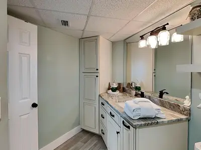 a bathroom with a sink and a large mirror at Sunbird Beach Resort 1207 West in Panama City Beach