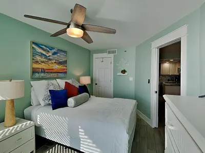 a bedroom with a bed with a ceiling fan at Sunbird Beach Resort 1207 West in Panama City Beach