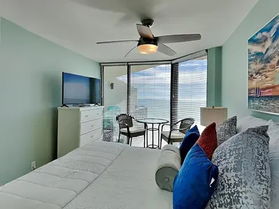 a bedroom with a large bed with a ceiling fan at Sunbird Beach Resort 1207 West in Panama City Beach