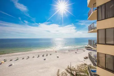 an aerial view of a beach with chairs and the sun at Sunbird Beach Resort 1207 West in Panama City Beach