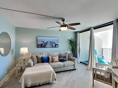 a living room with a couch and a ceiling fan at Sunbird Beach Resort 1207 West in Panama City Beach