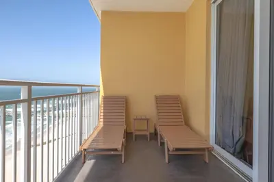 two chairs on a balcony with a view of the ocean at Beachfront Stunning view 100 ft long swimming pool in Panama City Beach