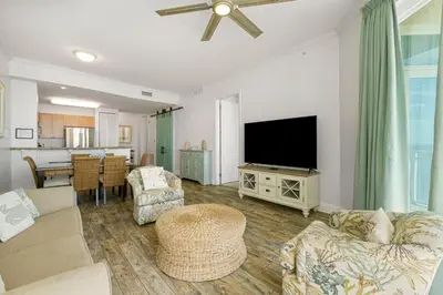a living room with a flat screen tv and a couch at Aqua #2209 in Panama City Beach