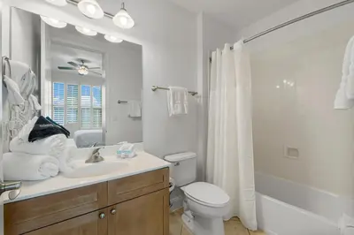 a white bathroom with a sink and a toilet at Aqua #2209 in Panama City Beach