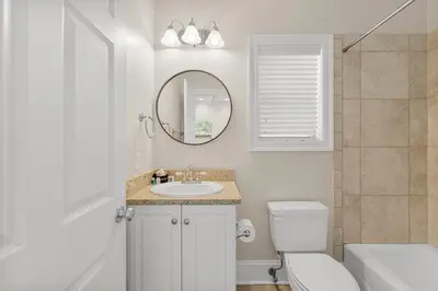 a bathroom with a sink and a toilet and a mirror at Spectacular Gulf Views w/ PRIVATE POOL! Remarkable 3BR 35BA Bedding for 12! in Panama City Beach