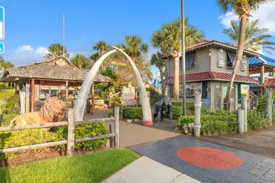 a park with a statue of a tiger in front of a house at Spectacular Gulf Views w/ PRIVATE POOL! Remarkable 3BR 35BA Bedding for 12! in Panama City Beach
