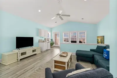 a living room with a couch and a flat screen tv at Spectacular Gulf Views w/ PRIVATE POOL! Remarkable 3BR 35BA Bedding for 12! in Panama City Beach