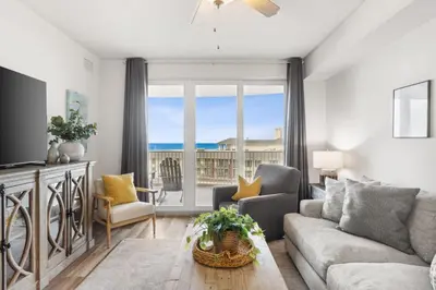 a living room with a couch and a tv at Calypso #3-607 in Panama City Beach