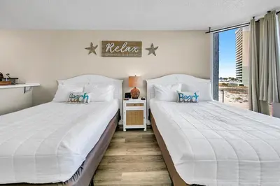 two beds sitting next to each other in a bedroom at Top of the Gulf 418 in Panama City Beach