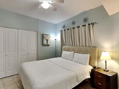 a bedroom with a white bed and a white closet at Shores of Panama #1702 in Panama City Beach