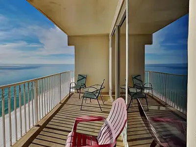a balcony with chairs and a view of the ocean at Shores of Panama #1702 in Panama City Beach