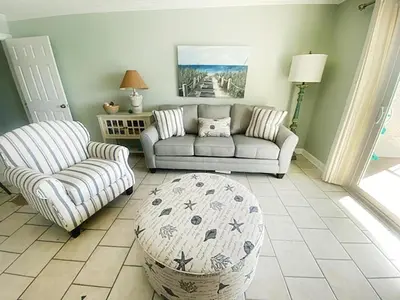 a living room with a couch and a chair at The Summit 1426 in Panama City Beach