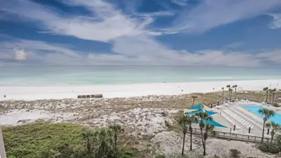 an image of a beach with a swimming pool and chairs at Dunes of Panama E605 2BR 2BA BEACHFRONT condo in Panama City Beach