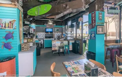 a store with a surfboard on the wall at Dunes of Panama E605 2BR 2BA BEACHFRONT condo in Panama City Beach