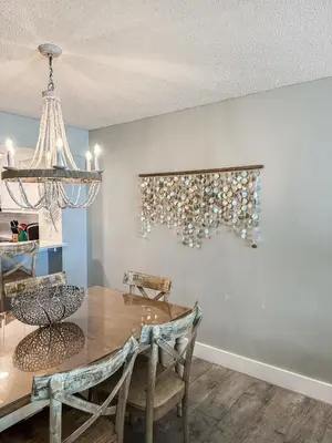 a dining room with a table and chairs and a chandelier at Dunes of Panama E605 2BR 2BA BEACHFRONT condo in Panama City Beach