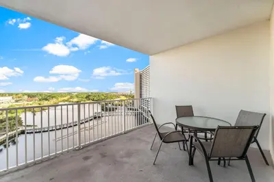 a balcony with a table and chairs and a view at Laketown Wharf #934 by Nautical Properties in Panama City Beach
