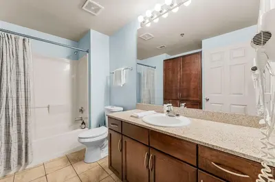 a bathroom with a sink and a toilet and a shower at Laketown Wharf #934 by Nautical Properties in Panama City Beach