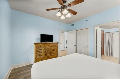 a bedroom with a bed and a ceiling fan at Laketown Wharf #934 by Nautical Properties in Panama City Beach