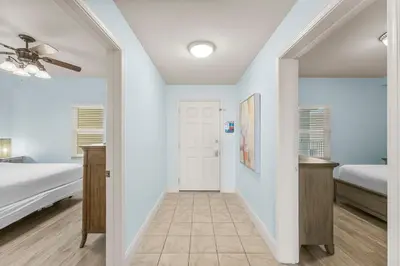 a hallway leading to a bedroom with a bed at Laketown Wharf #934 by Nautical Properties in Panama City Beach