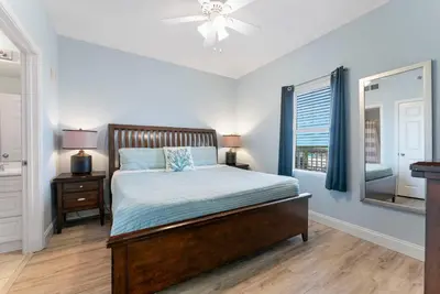 a bedroom with a bed and a window at Laketown Wharf #519 by Nautical Properties in Panama City Beach