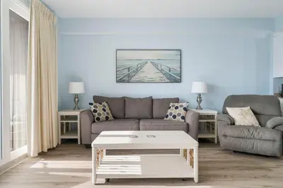 a living room with a couch and a coffee table at Laketown Wharf #519 by Nautical Properties in Panama City Beach
