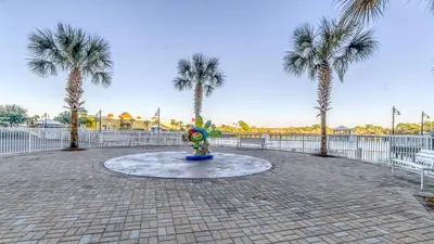 a fountain in a park with palm trees at Laketown Wharf #519 by Nautical Properties in Panama City Beach