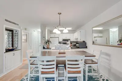 a kitchen and dining room with a table and chairs at Panama City Beach Bay Point Condo Close to Golf! in Panama City Beach