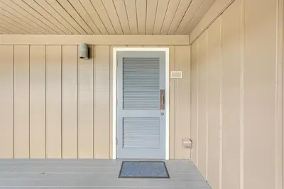 a door on the side of a house at Panama City Beach Bay Point Condo Close to Golf! in Panama City Beach