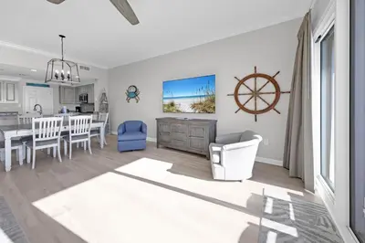 a living room with a kitchen and a dining room at Sterling Beach #1206 in Panama City Beach