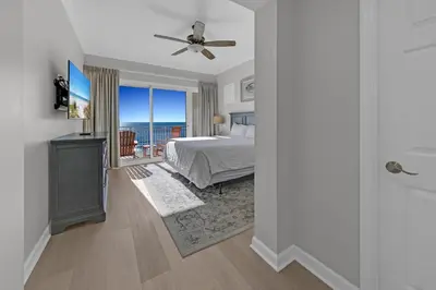 a bedroom with a bed and a view of the ocean at Sterling Beach #1206 in Panama City Beach