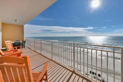 a balcony with chairs and a view of the ocean at Sterling Beach #1206 in Panama City Beach