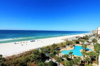 a view of the beach from the balcony of a resort at Sterling Beach #406 in Panama City Beach