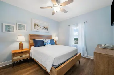 a bedroom with a bed and a ceiling fan at Laketown Wharf #1824 in Panama City Beach