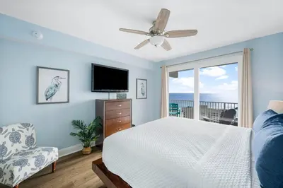 a bedroom with a bed and a tv and a window at Laketown Wharf #1824 in Panama City Beach