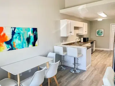 a kitchen with a table and chairs in a room at Tropical Gem/5 min beach walk in Panama City Beach