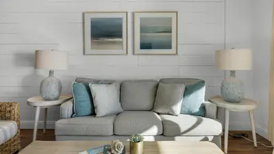 a living room with a couch and two lamps at BeachCrest 302 Wave and Sea in Santa Rosa Beach