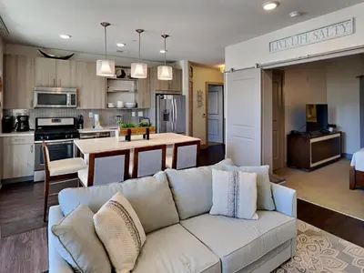 a living room with a couch and a kitchen at The Pointe on 30A #334 in Rosemary Beach