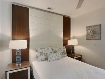 a bedroom with a white bed with two lamps at The Pointe on 30A #334 in Rosemary Beach