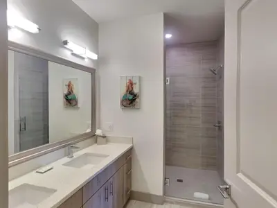 a bathroom with two sinks and a shower at The Pointe on 30A #334 in Rosemary Beach